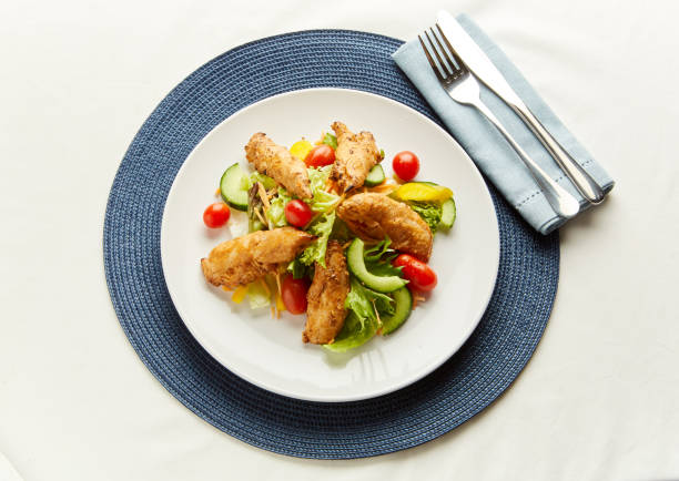 Fresh salad with lettuce, cherry  tomato and meat on dish