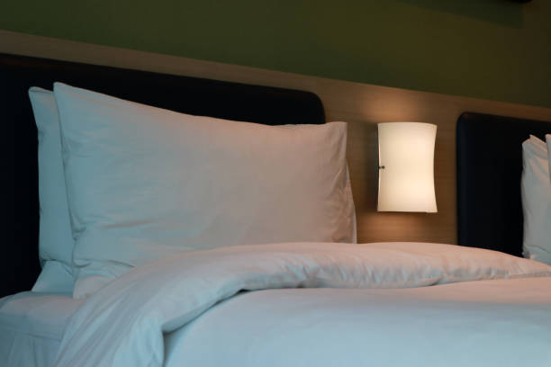 istock White pillow with white mattress and light dim on the bed. 1149207829