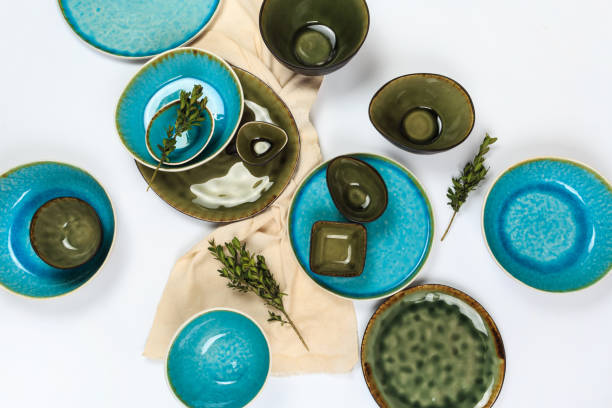 istock Simple rustic handmade blue crockery against white wooden wall: dish, stack of bowls. 1149209948