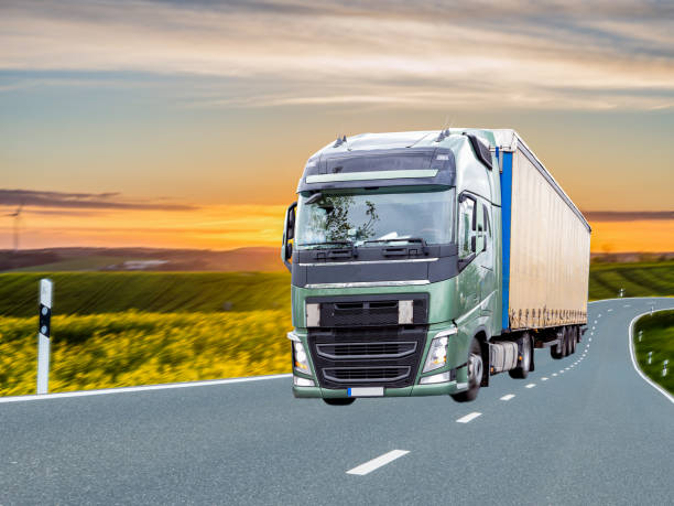 istock Truck with rape field at sunrise in spring 1149212733