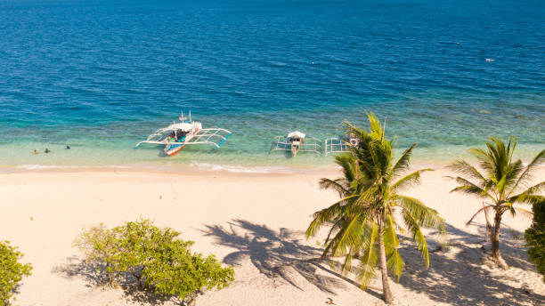 istock Tropical white sand beach. Island with a blue lagoon 1149213423