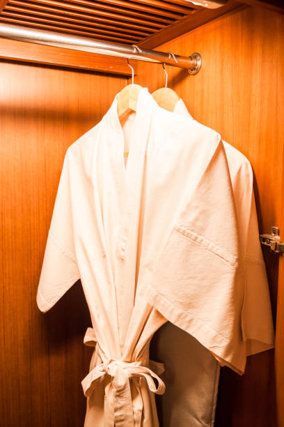 istock Bathrobes Hanging On Rack In Closet 1149213884