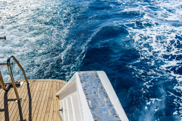istock Wave trace with white foam on a water surface behind of fast moving yacht 1149214274