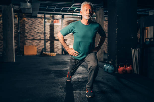 istock Active senior man doing lunges exercise him in a gym gym 1149214502