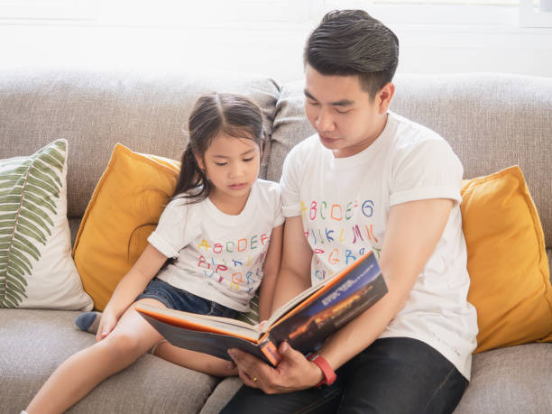 istock My father is reading a book for my daughter 1149216631