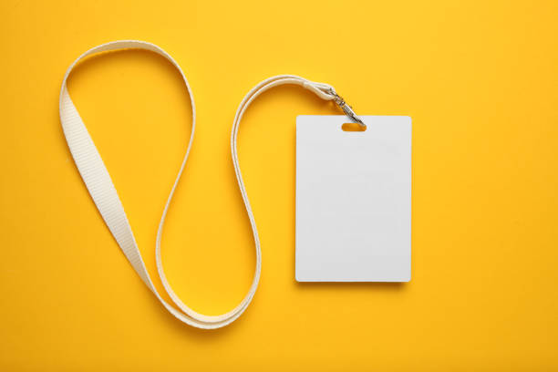 istock Tag id pass, plastic identification on yellow background. White blank badge mockup 1149218932