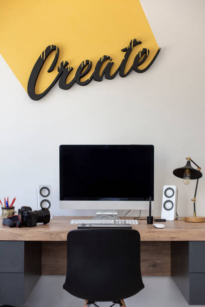 istock Creative Workspace in Office - Computer Desk with Camera and drawing tablet - On the wall written ''Create'' 1149219479