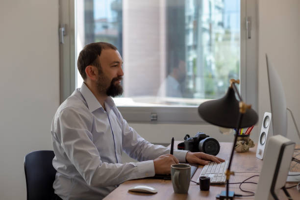 istock Business man in front of a computer working and smiling. Office workspace 1149219487
