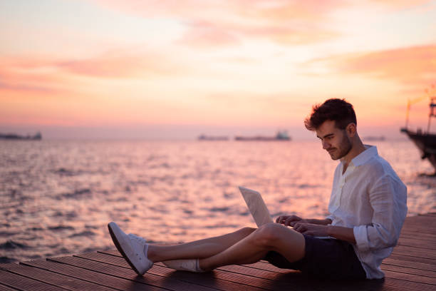 istock Male blogger writing article by the sea 1149219692