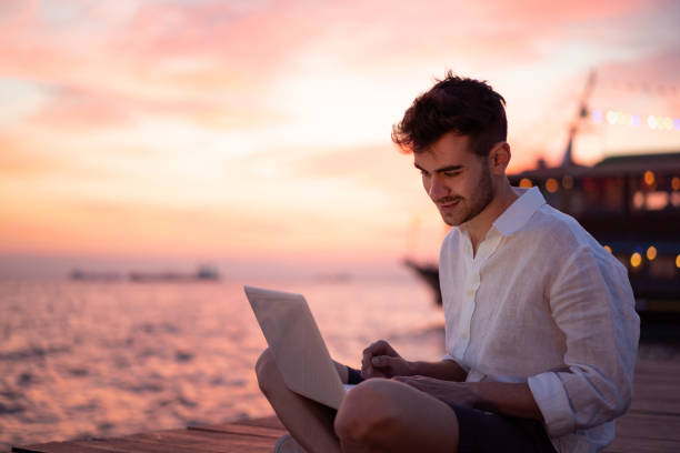 istock Male blogger writing article by the sea 1149219818