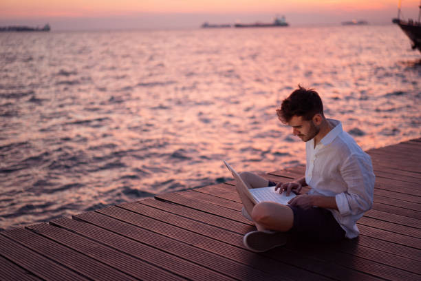 istock Male blogger writing article by the sea 1149220044