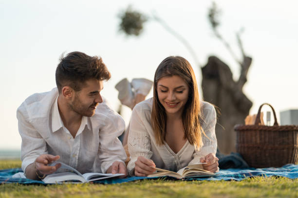 istock Couple enjoying a book on picnic 1149220650