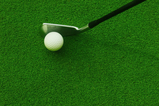 istock Golf balls and golf clubs on green grass 1149220882