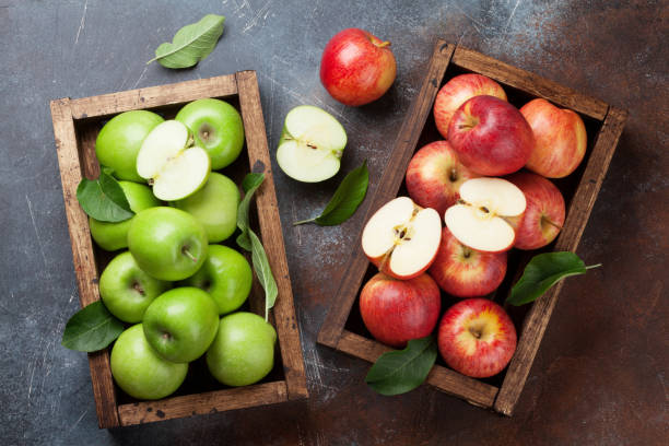 istock Green and red apples in wooden box 1149221872