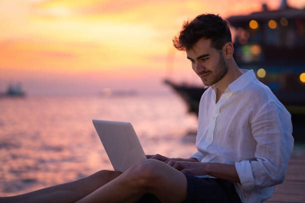 istock Male blogger writing article by the sea 1149222007