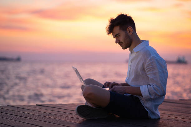 istock Male blogger writing article by the sea 1149222080