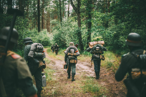 istock Rear View Of People Walking Amidst Trees In Forest 1149222165