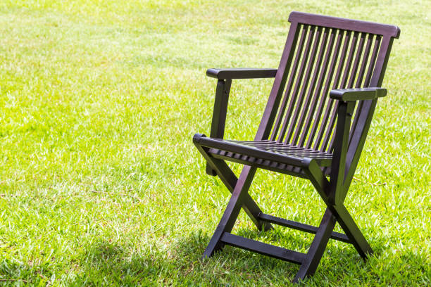 istock Black wooden chairs on the lawn. 1149222904