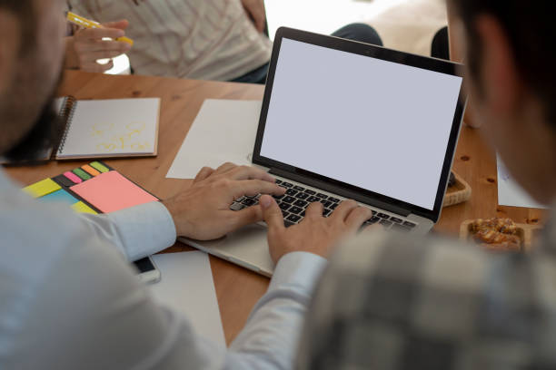 istock Creative work designers discussing new project and working on laptop. White screen 1149223678