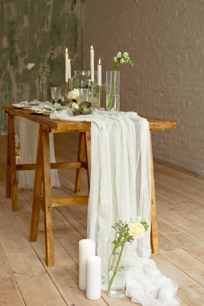 istock Boho wedding table setting, rustic decorations, gold and blue details, wooden table, bokeh. Luxury wedding decor. Monstera leaves and orchid flowers. 1149223758