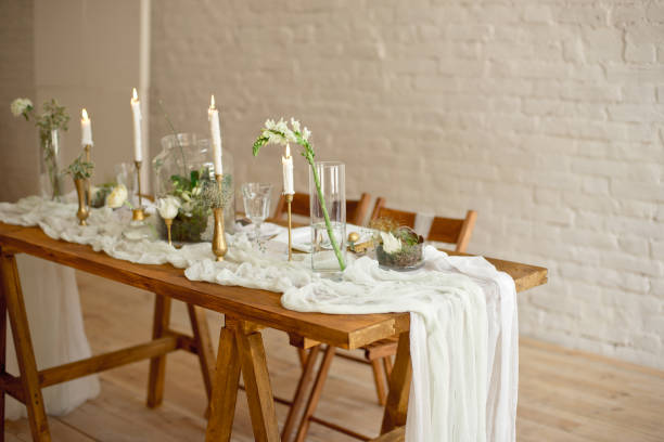 istock Boho wedding table setting, rustic decorations, gold and blue details, wooden table, bokeh. Luxury wedding decor. Monstera leaves and orchid flowers 1149223761