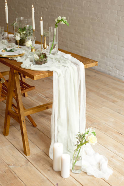 istock Boho wedding table setting, rustic decorations, gold and blue details, wooden table, bokeh. Luxury wedding decor. Monstera leaves and orchid flowers. 1149223762
