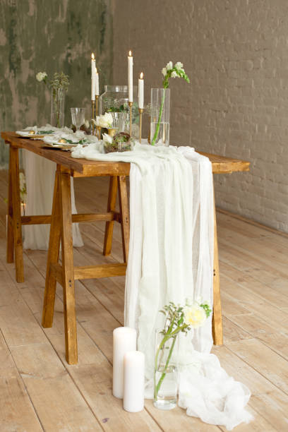 istock Boho wedding table setting, rustic decorations, gold and blue details, wooden table, bokeh. Luxury wedding decor. Monstera leaves and orchid flowers 1149223763