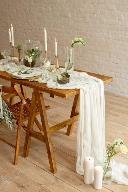 istock Boho wedding table setting, rustic decorations, gold and blue details, wooden table, bokeh. Luxury wedding decor. Monstera leaves and orchid flowers 1149223764