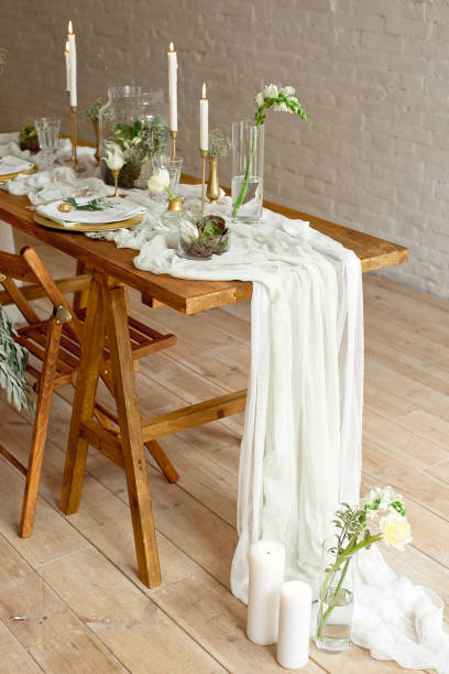 istock Boho wedding table setting, rustic decorations, gold and blue details, wooden table, bokeh. Luxury wedding decor. Monstera leaves and orchid flowers 1149223765