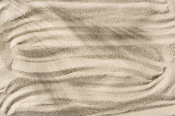 istock top view of beige sandy background with shadow and smooth waves 1149225496