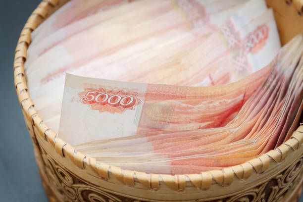 Paper banknotes Russian ruble in denominations two and five thousand pocket backpack with inscription Russia
