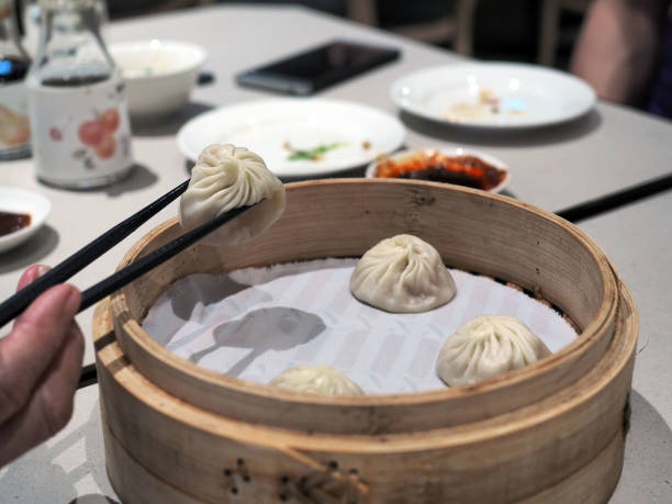 istock Picks steamed hot xiao long bao (steamed dumpling with soup inside) with chopsticks 1149230184