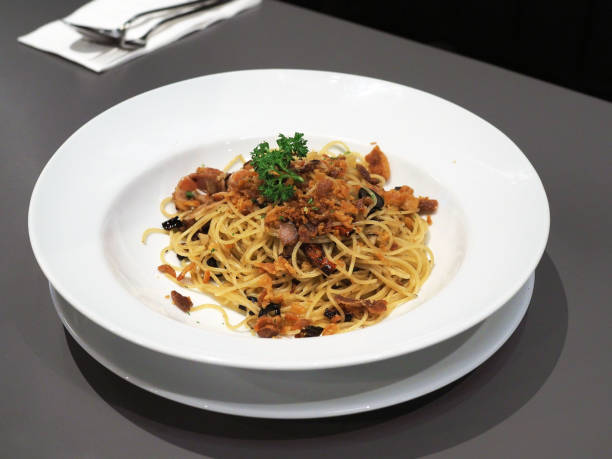 istock Spicy spaghetti bacon - Spaghetti with bacon, basil, garlic, tomato, black olive and parsley. 1149230363