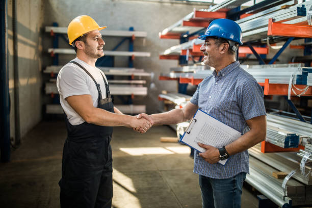 istock Happy foreman greeting manual worker in industrial building. 1149232540