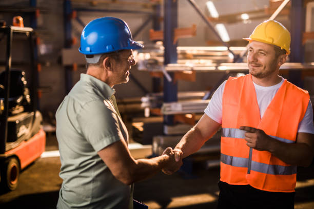 istock Happy manual worker greeting in control inspector aluminum mill. 1149232581
