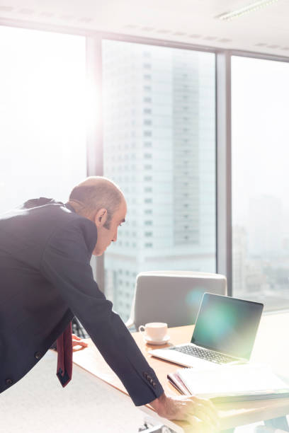 istock Mature businessman working in boardroom at office 1149235332
