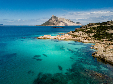 Photo taken by drone with a view of Tavolara and crystal clear water of the sea of Sardinia San Teodoro
