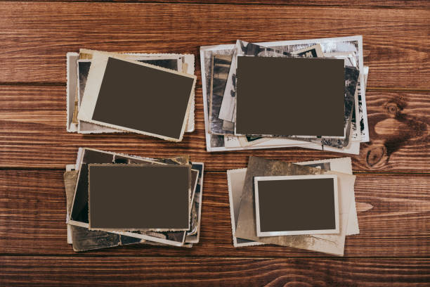 istock Stack old photos on table. Mock-up blank paper. Postcard rumpled and dirty vintage. Retro card 1149236125