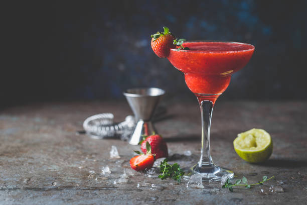 Ice Strawberry cocktail Ice Strawberry alcohol cocktail with lime and rum in a glass daiquiri stock pictures, royalty-free photos & images