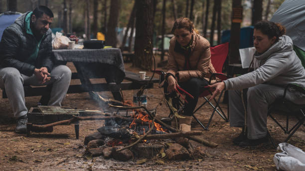 istock Friends sitting in front of camp tent fire 1149237658