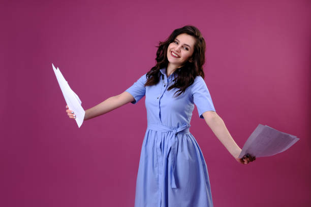 istock Attractive smiling business woman with documents in her hands. 1149238085
