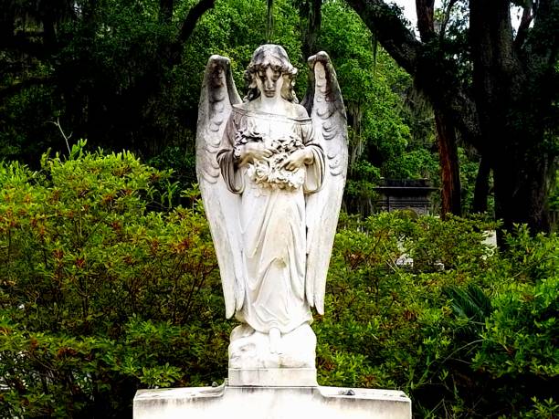 Statue of an angel with crosses in Bonaventure Cemetery, Savannah Georgia