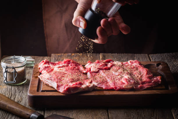istock Man cooking meat steaks 1149239258