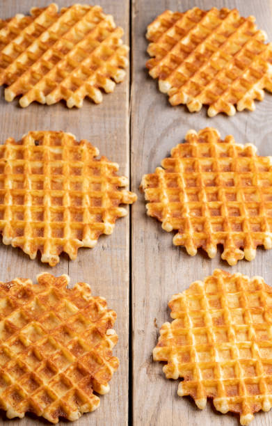 istock Six fresh baked round wafers on wooden table. 1149239464
