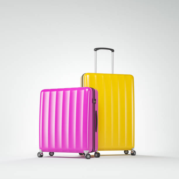 istock Pink and yellow suitcases over white 1149241090