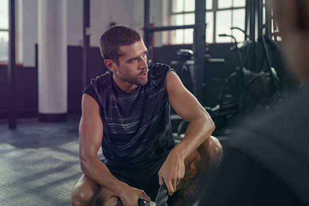 istock Tired man sitting after battle rope exercise 1149241508