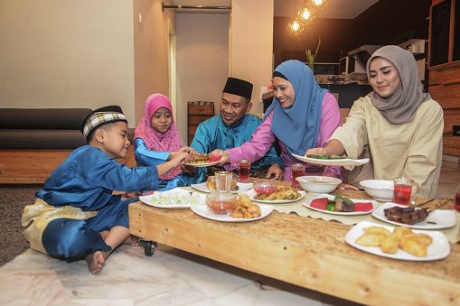 Malaysian Muslim family celebrating Eid-Ul-Fitr at home