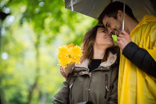 istock Couple under umbrella during rainy spring day 1149242227