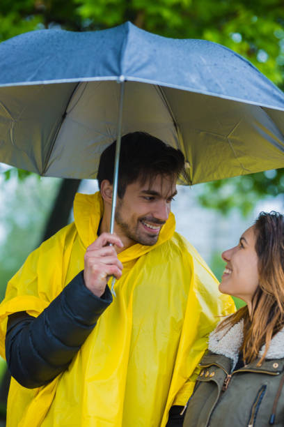 istock Couple under umbrella during rainy spring day 1149242616