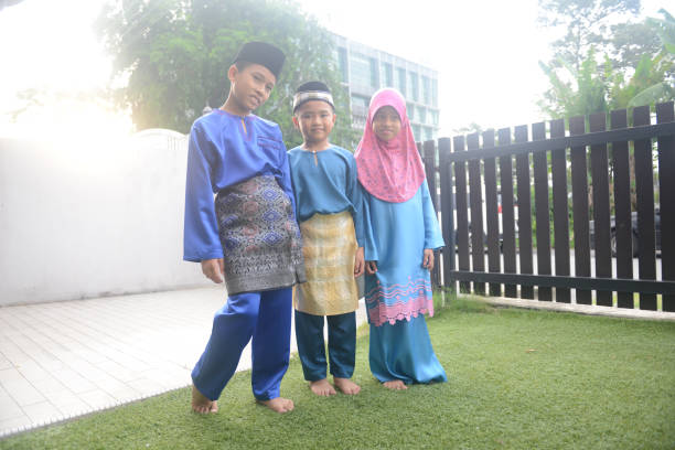 istock Malaysian children in traditional costume at home during Eid celebration 1149242676
